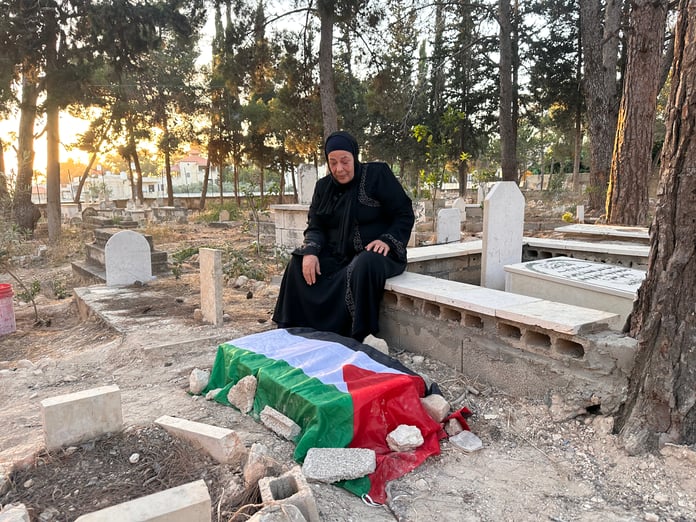 Maarouf Zaid holds a photo of his three-month-old son Ahmad who died at an Israeli checkpoint in the occupied West Bank