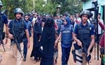 Bangladesh counter-terrorism police officers detain suspected Islamic extremists during an anti-militant operation