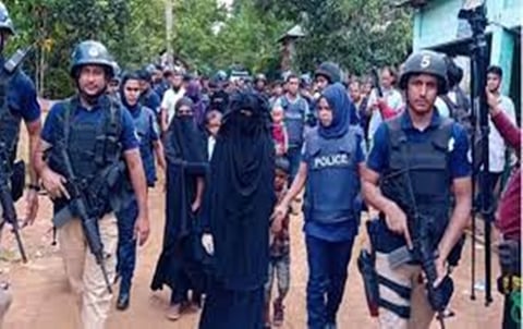 Bangladesh counter-terrorism police officers detain suspected Islamic extremists during an anti-militant operation