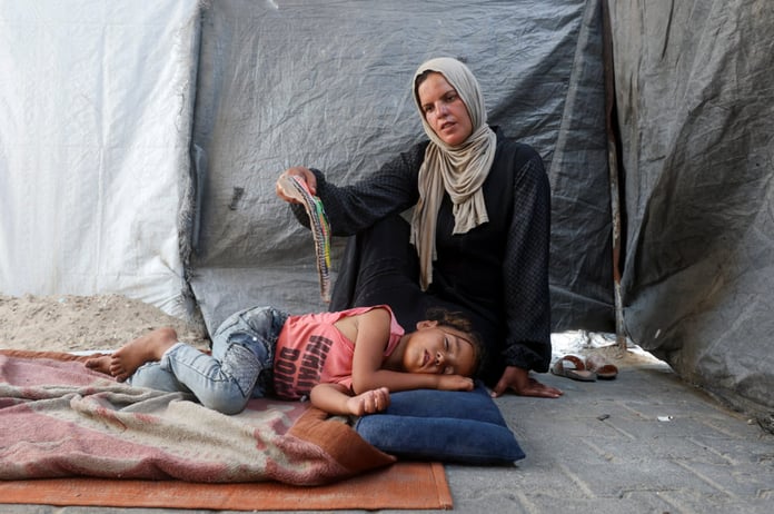 Displaced Palestinians sheltering at a school in Khan Younis as Gaza marks 1000 days of war