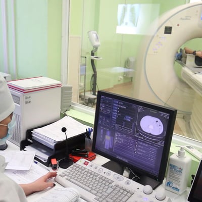 Radiology technician performing CT scan in hospital as hedge funds push healthcare bets to five year high