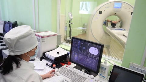 Radiology technician performing CT scan in hospital as hedge funds push healthcare bets to five year high