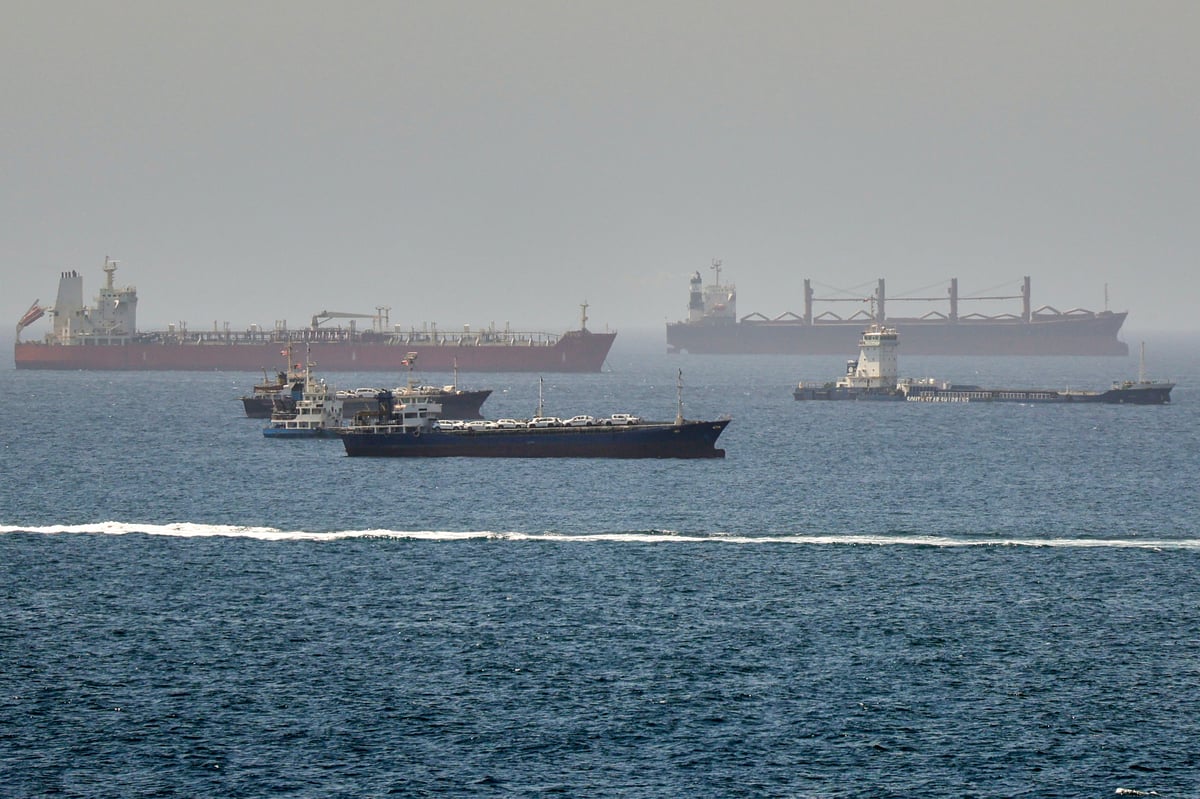 Rescue boats approach burning oil tankers in the Strait of Hormuz as the US carried out its tenth night of strikes on Iran