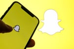 Snapchat app interface showing Snap Map with the new Now Playing music feature powered by Spotify, displaying a friend's current track in real time