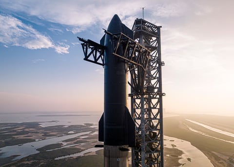 SpaceX Starship rocket on the launch pad at Boca Chica Texas with coastline in background