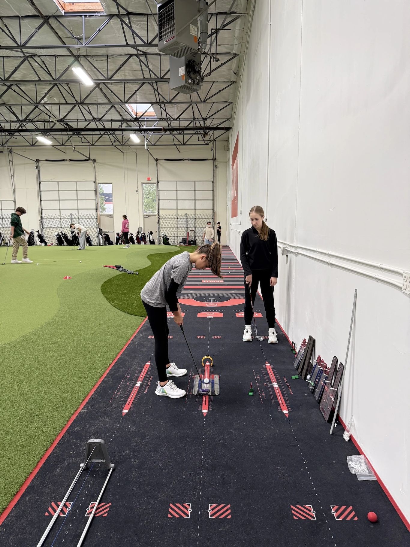 5,000 sq ft putting and chipping green at Portland Indoor Golf Club, with real-quartz sand bunker