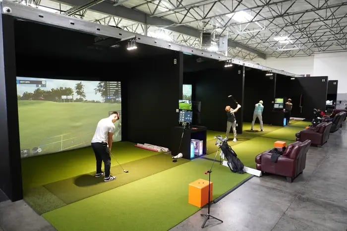 Golfers practicing at hitting bays
