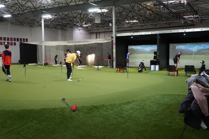Junior golfers practicing putting
