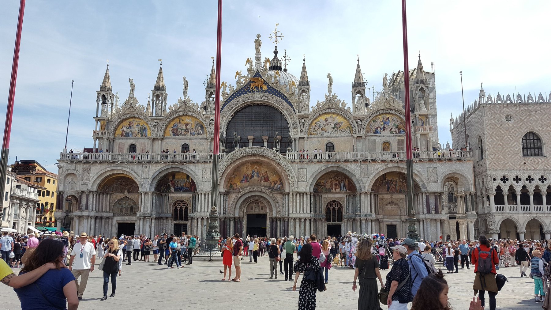 A grand church decorated with religious images and gold mosaics.