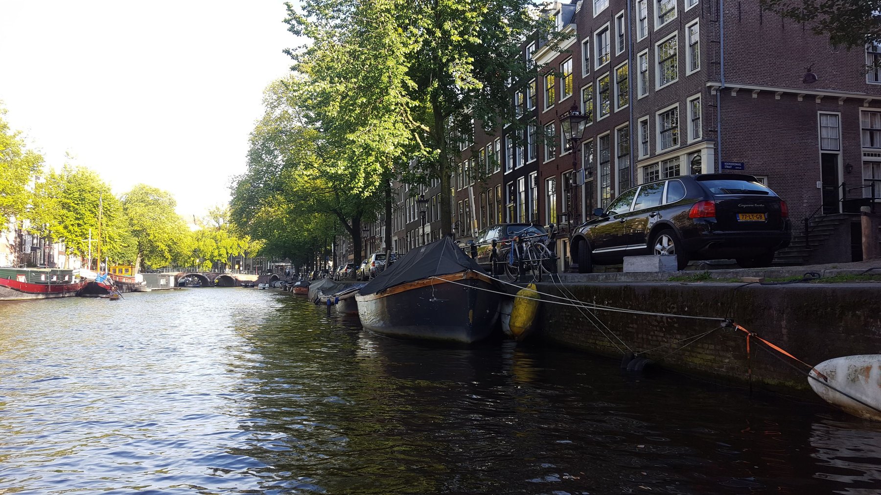 Boats lining a wide canal.