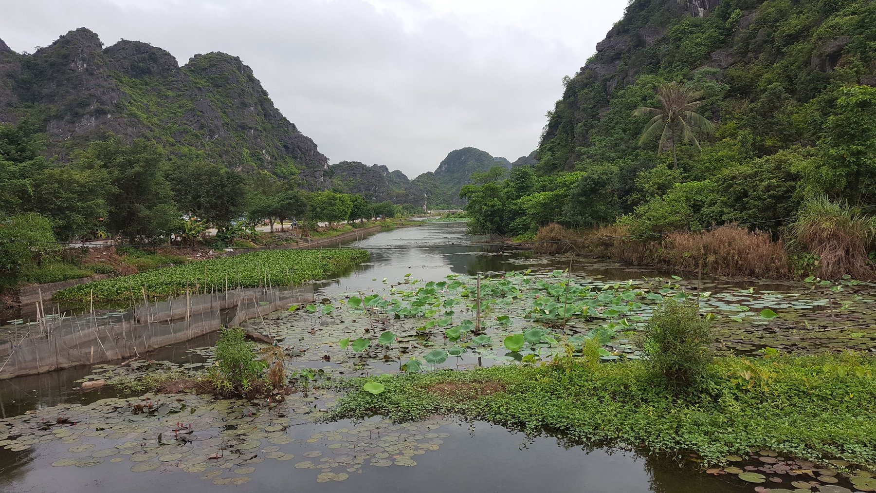 A calm river surrounded by mountains.