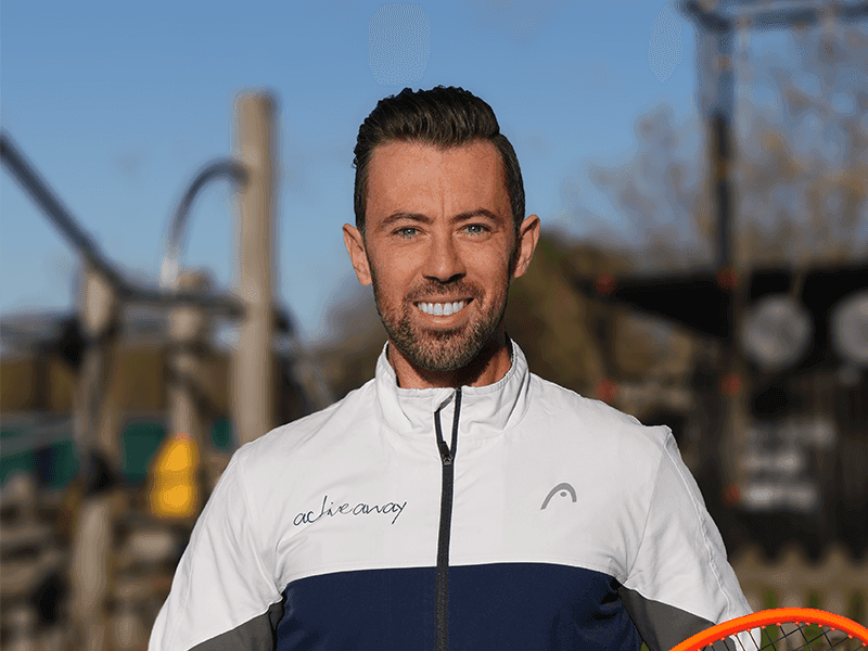 Portrait of Josh Thompson in a sporty Active Away jacket, smiling outdoors