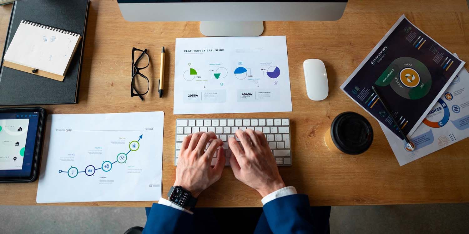 Investor reviewing charts and reports at a desk