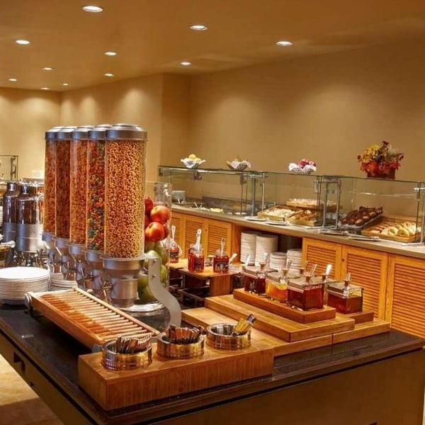 El Conquistador Gallery breakfast buffet with cereals, fruits, pastries, and jams on display in an elegant dining setup.