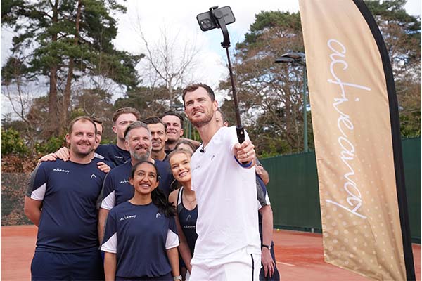 Jamie Murray taking a group selfie on a tennis court with participants of the Active Away tennis programme.