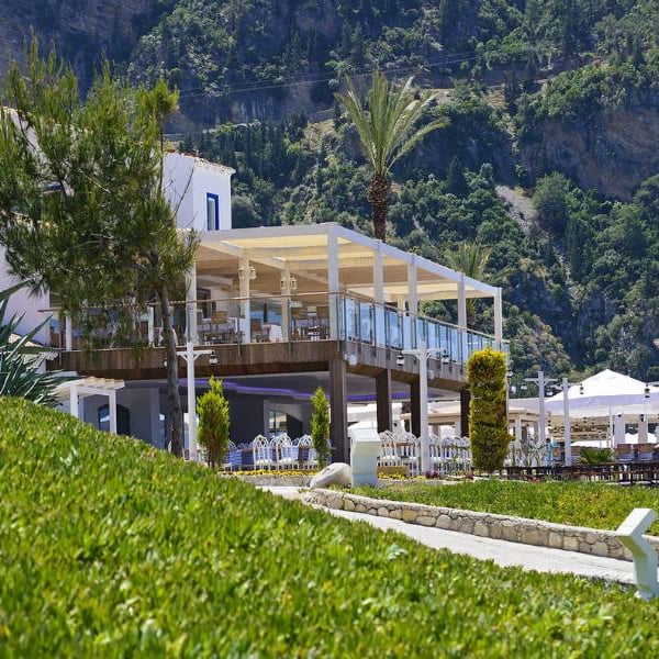 Outdoor restaurant at Liberty Lykia Family resort with scenic mountain views and lush greenery.