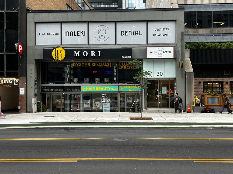 Exterior perforated window graphics installed for storefront privacy