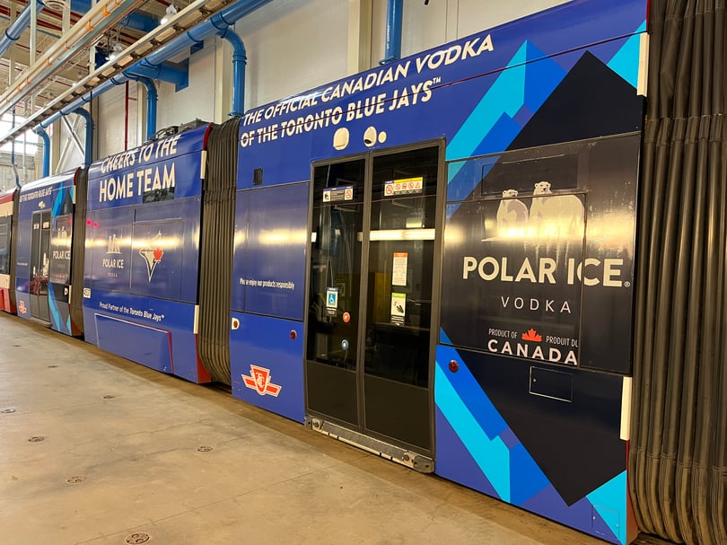 Polar Ice advertising wrap installed across the panels, doors, and articulation joints of a Toronto streetcar
