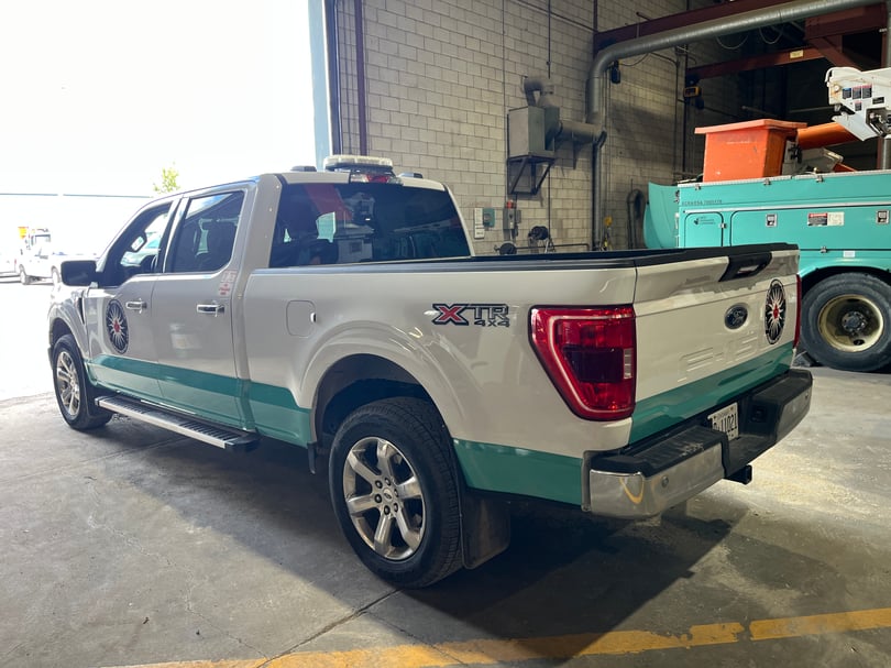 Corporate fleet vehicle wrap installation on service truck