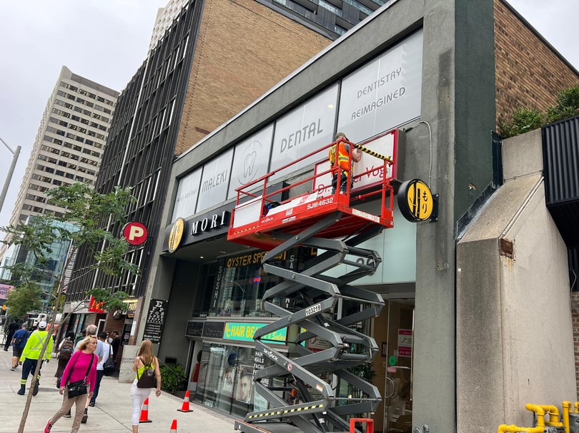 Exterior window graphics installation on a building front in Toronto
