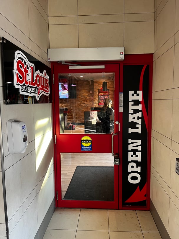 Branded interior glass graphics installed in a Toronto restaurant entrance