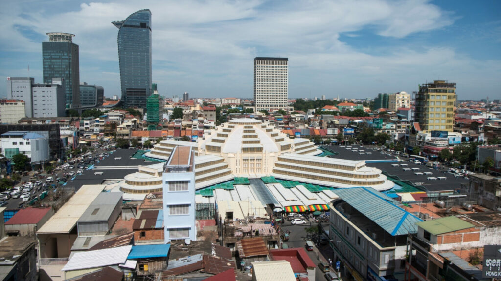 City view of the white roof of the Central Market with tall buildings behind