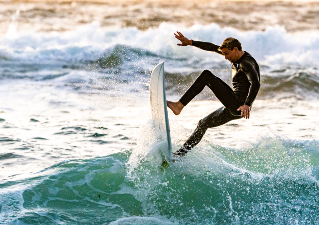 A male surfer doing a top-turn on a wave