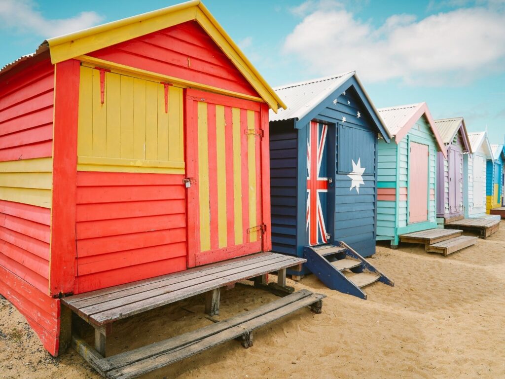 6 bathing boxes in different colours on the beach