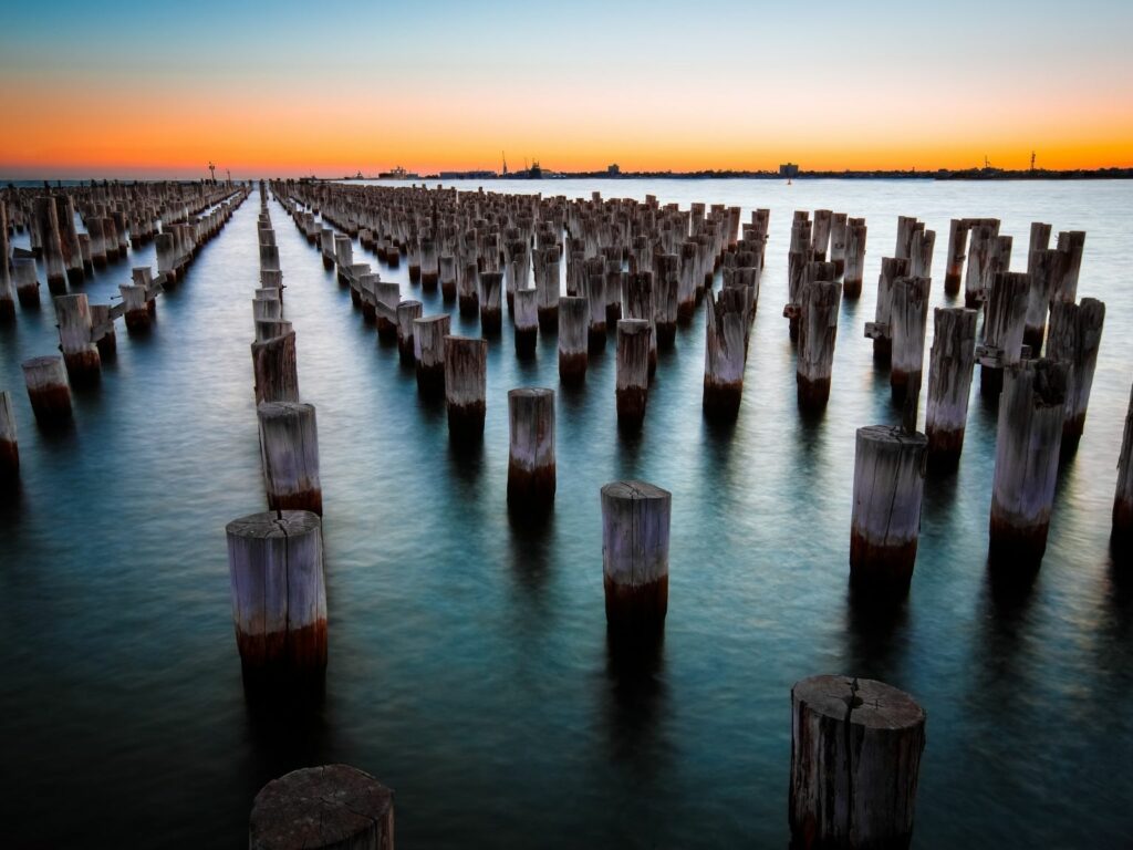 Numerous of wooden foundations standing in the water at Princes Pier