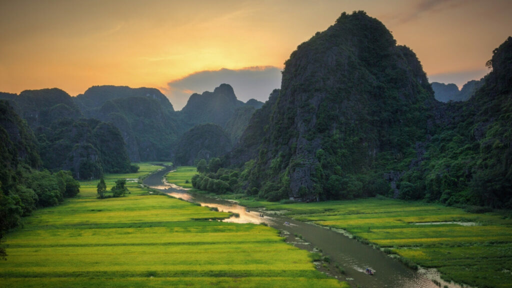 The beautiful green nature in Tam Coc, Vietnam, with limestones, river and green rice fields