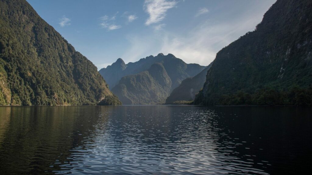 View of the fjord and mountains from inside the fjord of Milford Sound