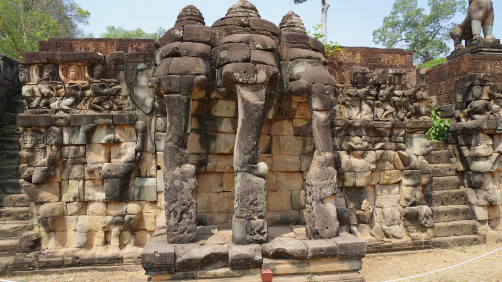 Three elephant head statues on the Terrace of the Elephants in Cambodia