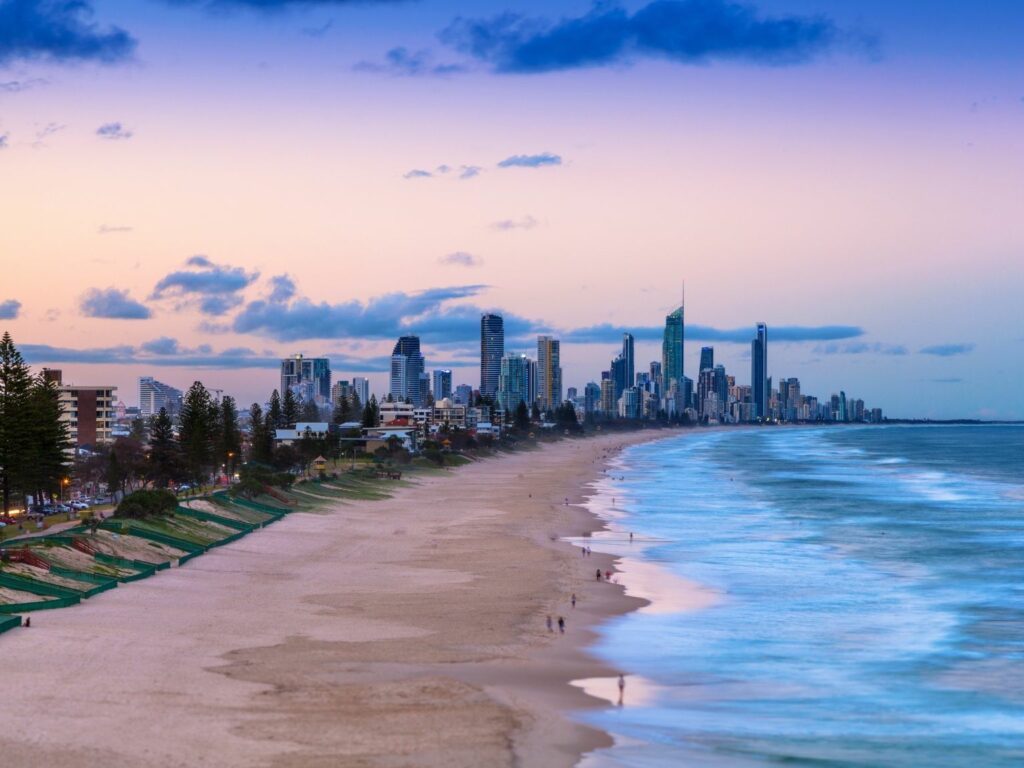 The beach and city skyline of Gold Coast during twilight