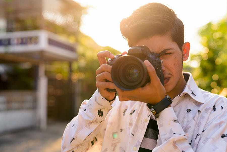 Portrait of young handsome Indian teenage boy in the streets outdoors