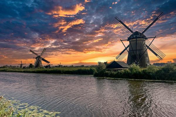 Dutch windmills at golden hour in Leiden, Netherlands &mdash; the F/65 Group workshop destination.