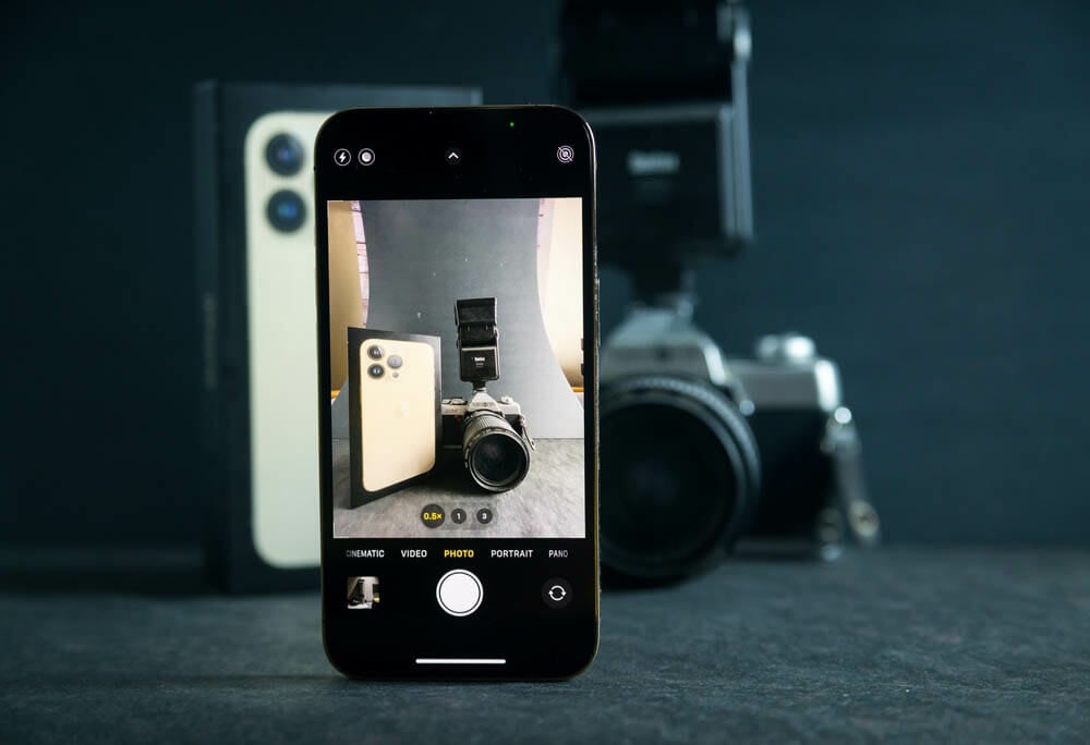 Kuala Lumpur , Malaysia - 8 October 2021 : Photo of brand new Iphone 13 with camera app taking photo of mirror less camera and Iphone 13 official box.
