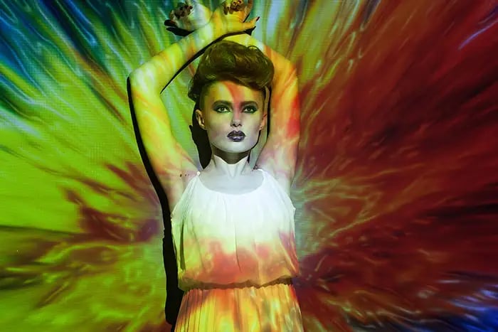 A creative-lighting portrait &mdash; coloured light shaped on a face for dramatic effect.