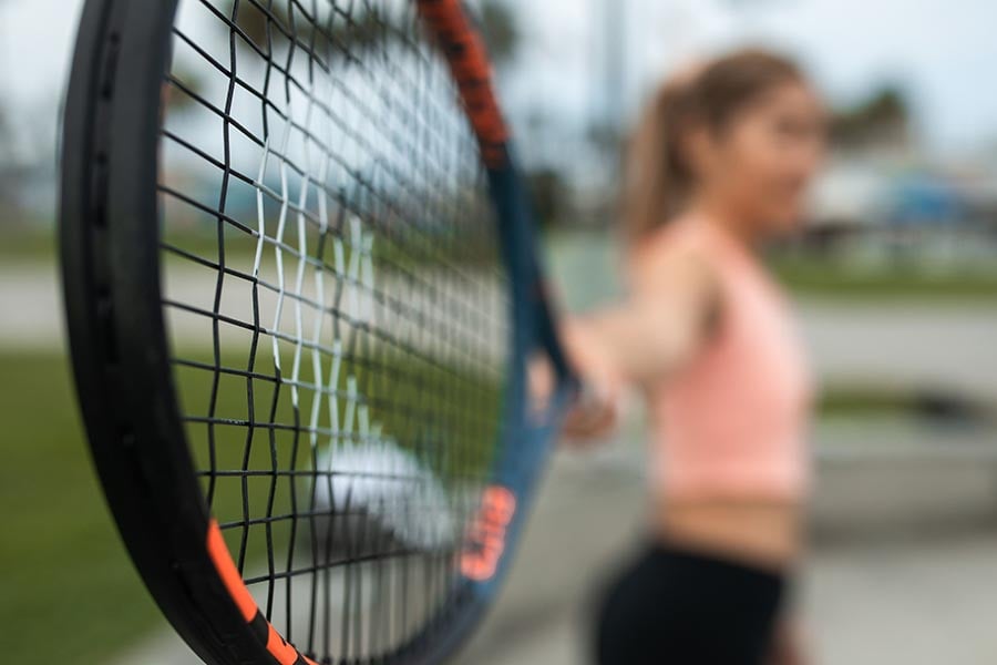 Outstretched arm holding tennis racket