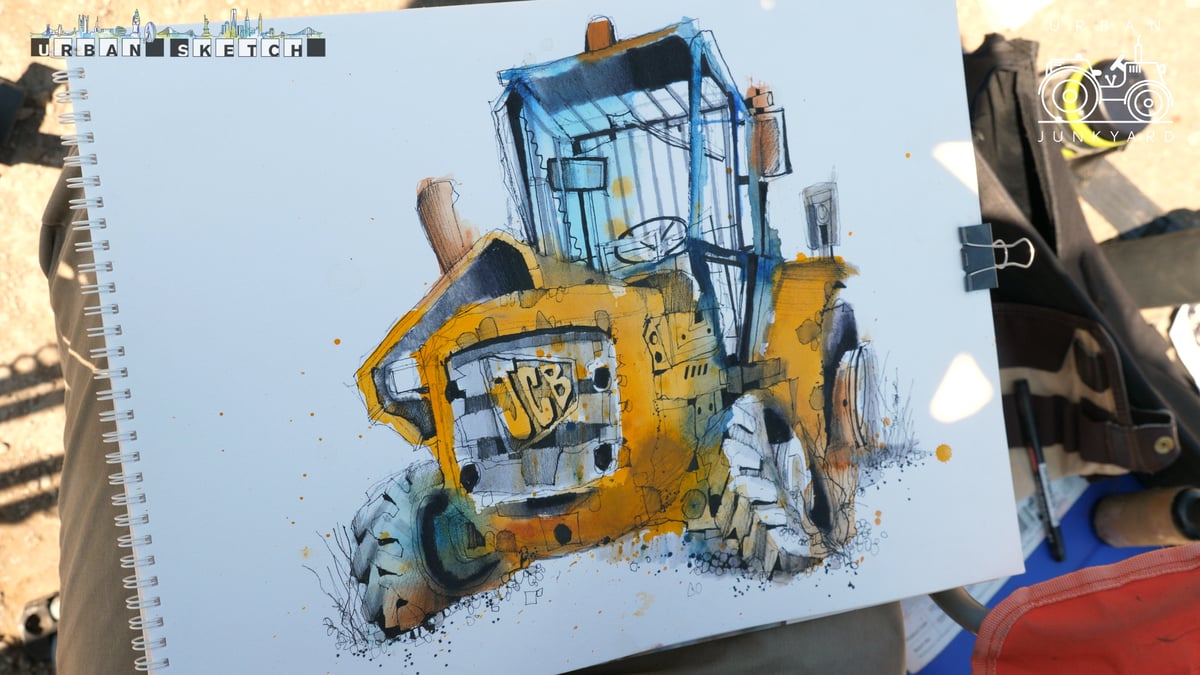 Ian Fennelly's ink and watercolour sketch of a yellow JCB excavator, held up in sunlight.