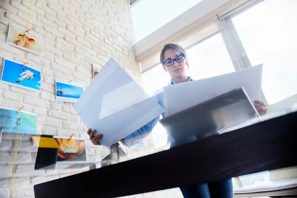 Lady comparing printed photos