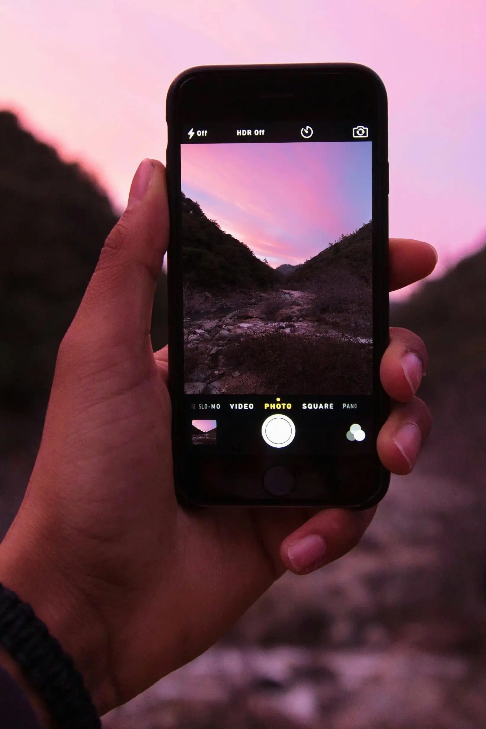iPhone taking photo of a sunset sky