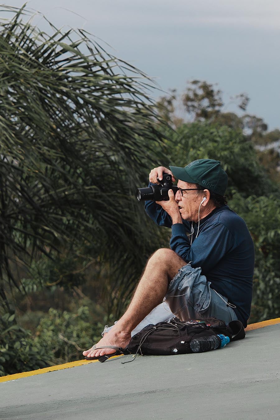 man sat down taking photos