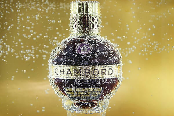 A high-impact product shot of a Chambord bottle with splash &mdash; product photography from the iPhotography Home Projects Course.