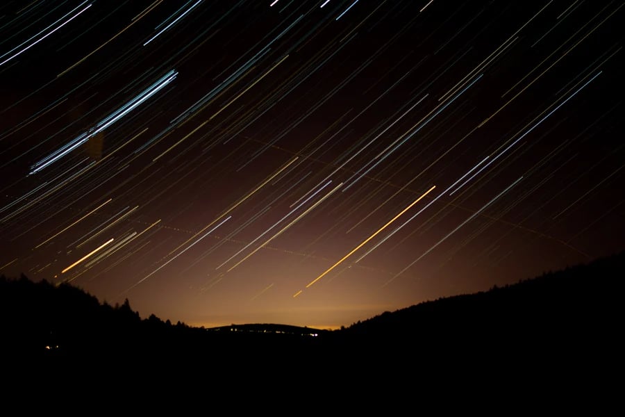 Star-trail photograph over a hillside by iPhotography tutor Rebecca Santo.