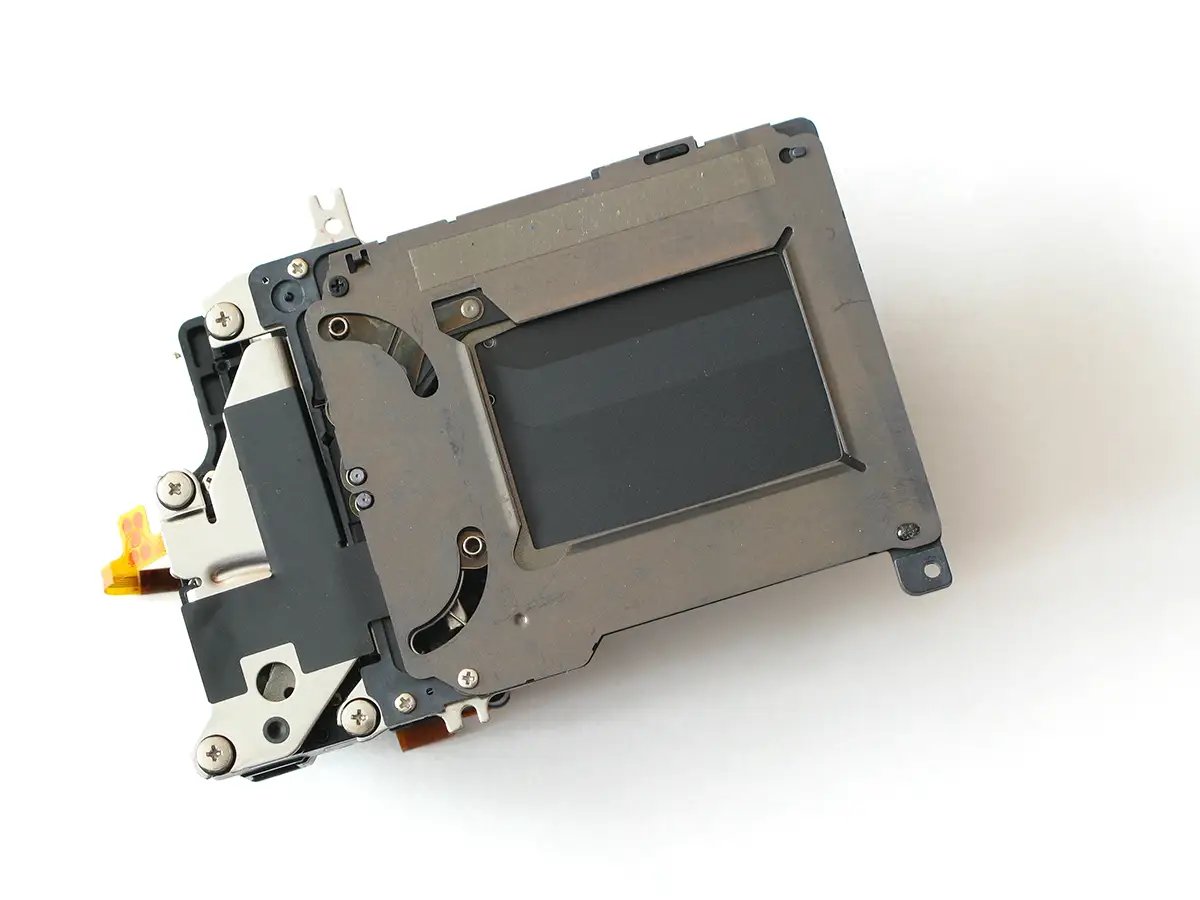 A camera sensor part removed from the camera on a white background