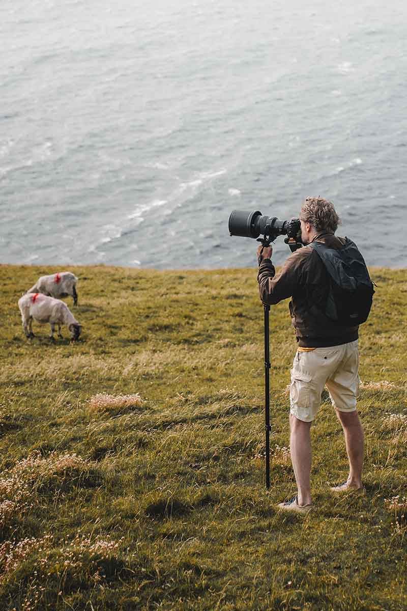 man taking photos with a monopod