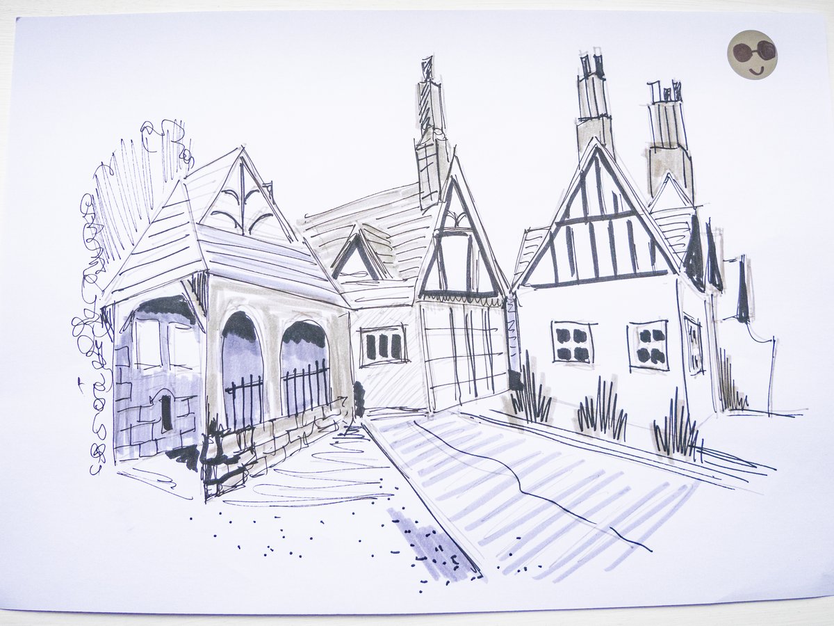 A pen and watercolor sketch of a charming row of Tudor-style cottages and buildings featuring distinctive steep gabled roofs with half-timbering, arched doorways, and mullioned windows. The composition is rendered in blue ink with light blue watercolor wash, depicting a period street scene with strong linear perspective leading down a cobbled or striped street. A whimsical cartoon face in the upper right corner adds a playful element to the architectural study.