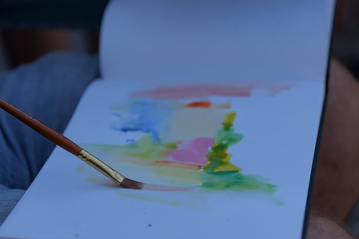 Two watercolours blending wet-in-wet on the page, mixed directly on the paper rather than in the palette