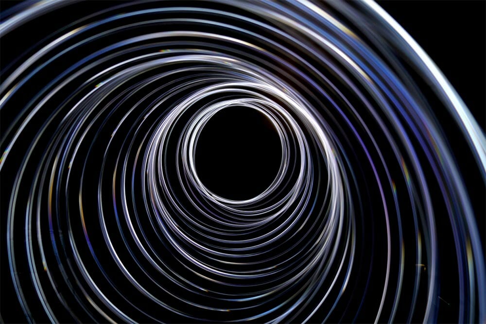 trails of light going down a funnel