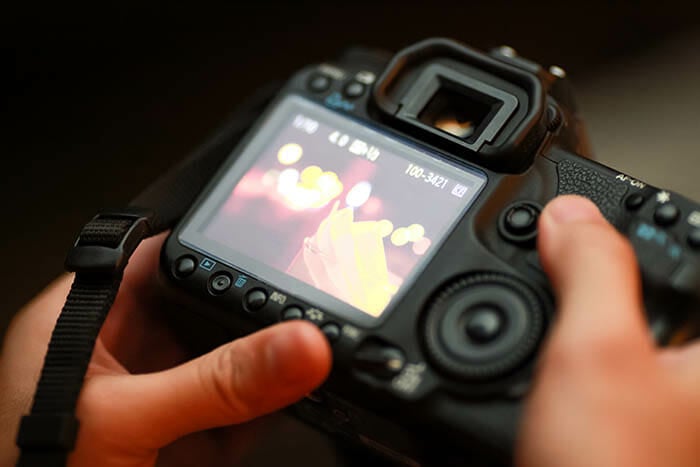 Canon camera screen held in hand